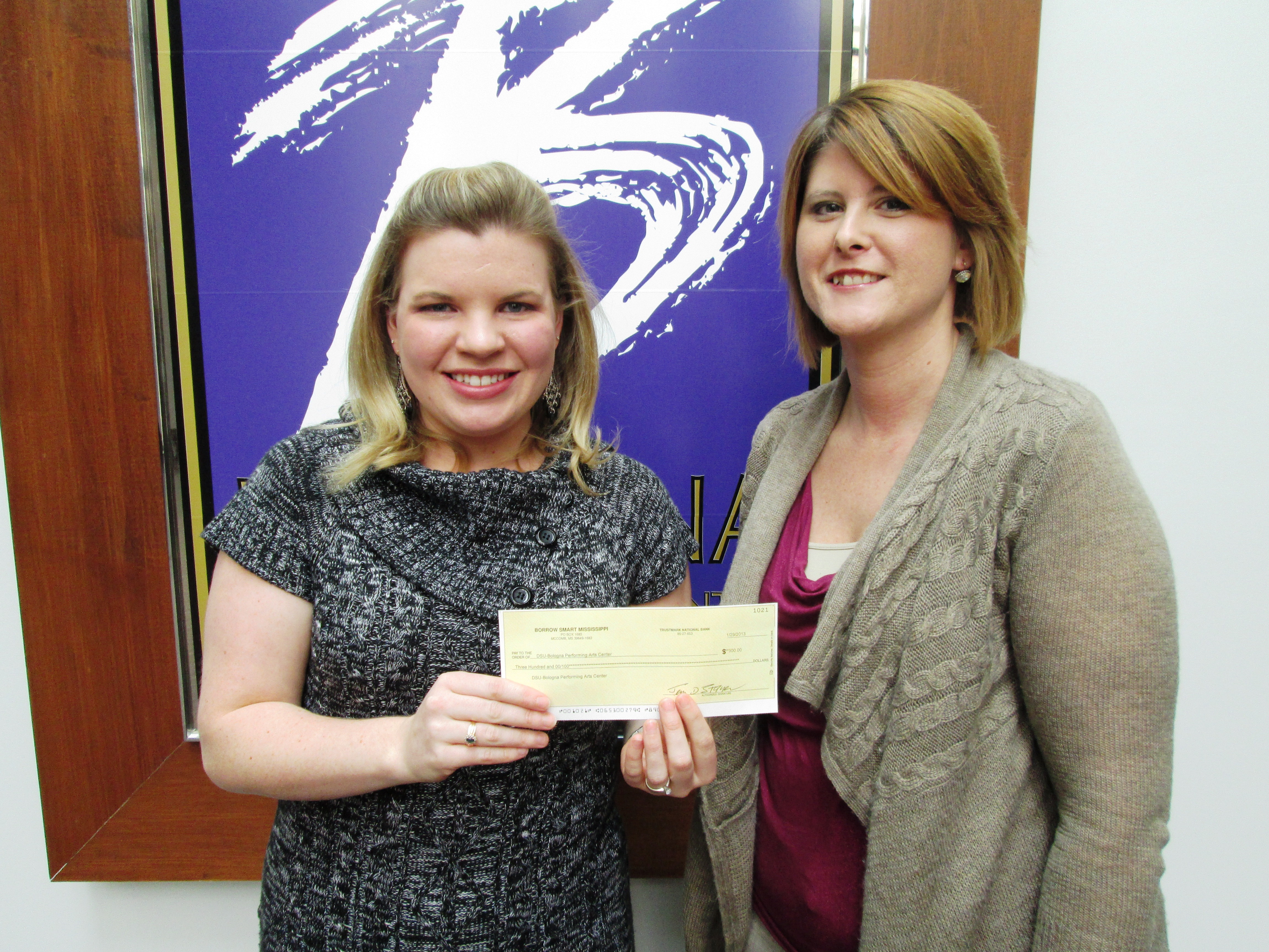 Charity Kilgore (right), Borrow Smart Mississippi Representative, presents a check for the Janice Wyatt Mississippi Summer Arts Institute to Whitney Cummins, BPAC Interim Arts Education Coordinator.